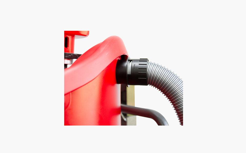 The image showcases a close-up view of the Mega Hippo mixing station, prominently displaying its vibrant red color. On the side of the mixing station, a vacuum hose is securely connected via the Mega Hippo Vacuum Adapter Cuff, emphasizing the seamless integration of the two components. The hose extends outward, indicating its readiness for operation and its capability to efficiently extract dust and debris during the mixing process. Set against a neutral background, the Mega Hippo mixing station stands out, symbolizing efficiency, cleanliness, and advanced functionality in the realm of mixing solutions.